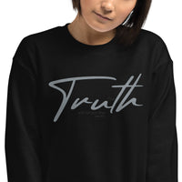 Close Up Of A Woman Wearing A Black Truth Sweatshirt