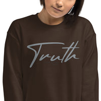 Close Up Of A Woman Wearing A Brown Truth Sweatshirt