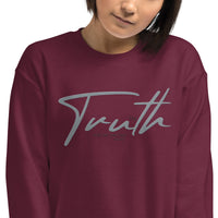 Close Up View Of Woman Wearing A Maroon Truth Sweatshirt
