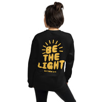 Woman Wearing A Black Be The Light Sweatshirt