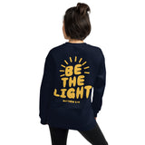 Woman Wearing A Navy Be The Light Sweatshirt