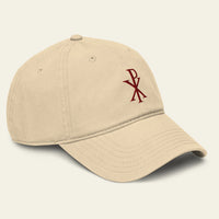 Beige cap with a red CHI RHO on a beige background