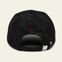 Black cap with a red Memento Mori on the back against a beige background