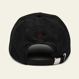 Black cap with a red Memento Mori on the back against a beige background