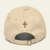 Beige cap with a red cross emblem